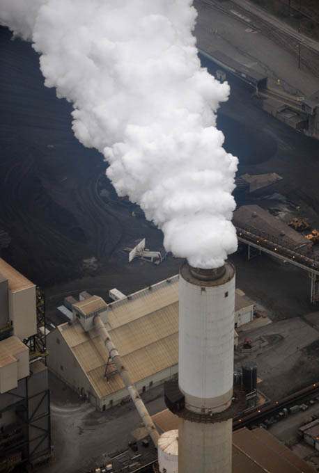 Smokestack on a low ceiling overcast afternoon.